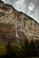 Frontal view of the famous Staubbach falls in the Lauterbrunnen valley on an overcast day in summer. Jungfrau region, Bernese Oberland, Switzerland