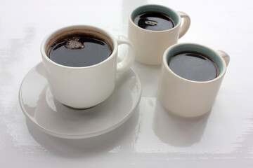 Tree espresso cup of coffee on white table background. Overhead view. Coffee break