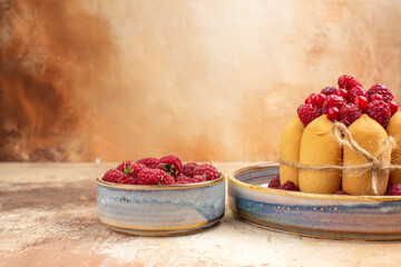 Horizontal view of freshly baked soft cake with fruits on mixed color background