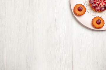 top view delicious cakes with grapes inside plate on white floor pie dessert cake