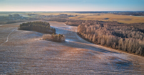 Winter Agricultural field under snow panorama. December Rural landscape