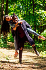 african american man with mixed race asian woman walking in the park