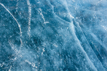 Abstract ice texture. Cracks in a piece of blue ice. Wave.