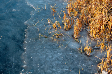 Abstract ice texture. Cracks in a piece of blue ice. Wave.