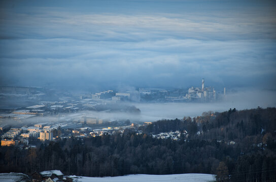  morning mood in a swiss village, the fog envelops the houses, the fog engulfs part of hinwil zurich oberland