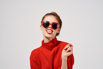 woman in fashionable glasses and in a red sweater gestures with her hands