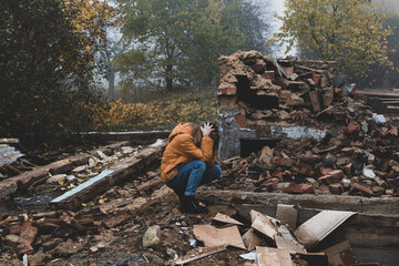 A young girl cries over a burned-out house
