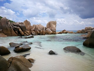 Obraz premium La Digue island beach with cliffs in Seychelles