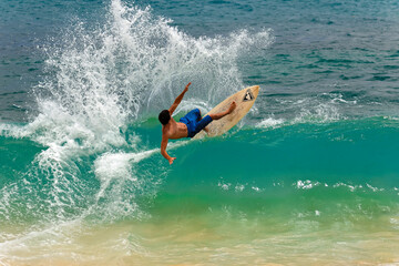 Surfer whipping the curl in Hawaii