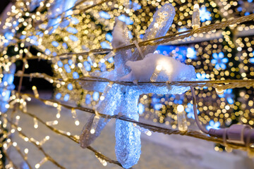 Selective focus on LED Christmas lights. Yellow lights on a blurred background. Magical New Year's lighting.