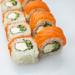 Japanese cuisine. Sushi roll with salmon on white background.
