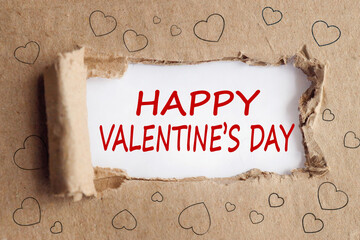 happy valentine's day, text on white paper on a background of torn paper in hearts