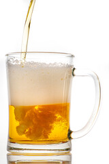 Pouring fresh beer into a glass mug. A glass container for drinking alcohol.