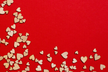 Fototapeta na wymiar Red romantic background for valentine's day banner with plywood hearts. Copy Space.