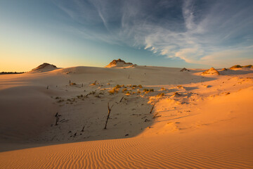 Moving dunes in the Słowiński National Park during sunset. Amazing textures on sand bathed in golden light.
