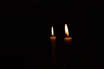 Burning candles in the dark with black background