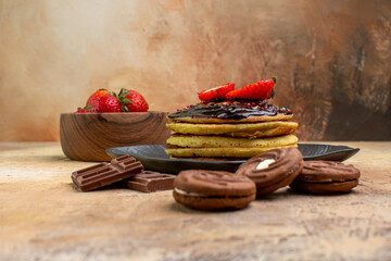 front view yummy sweet pancakes with cookies and fruits on wooden desk dessert cake sweet pie