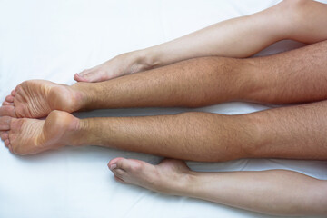 Love between a man and a woman with naked bodies. having sex in a white bed. Intimate background theme