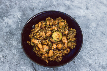 plant-based food,  vegan potato mushroom and zucchini stir fry with alomnds and sesame seeds