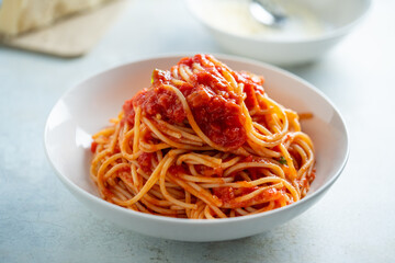 Spaghetti with tomato sauce and basil on a plate