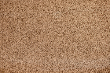 Obraz premium Closeup of a wavy texture of clean sand in the wind. A close-up of the wet texture of clean sand.