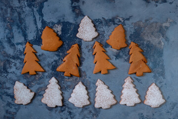 Decorated gingerbread christmas trees on wooden background