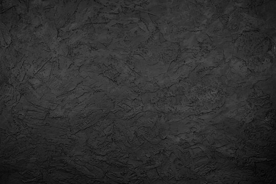 Black stone background texture. Black stone plaster cement. Grunge wall. Graphite