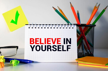 text Believe In Yourself written in notebook