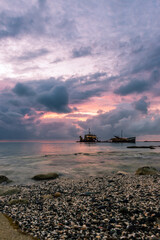 Cloudy sunset with a shipwreck on a calm sea at Saint Martin,Antilles
