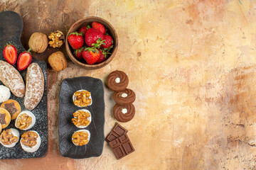 top view yummy sweets with fruits candies and cookies on wooden desk sweet sugar biscuit