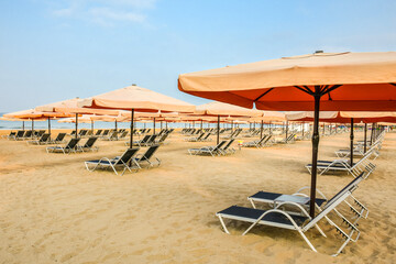 Beautiful umbrella and chair near The Mediterranean Sea in hotel. Resort - vacation concept. Summer holidays. Sand on the beach. Empty beach.