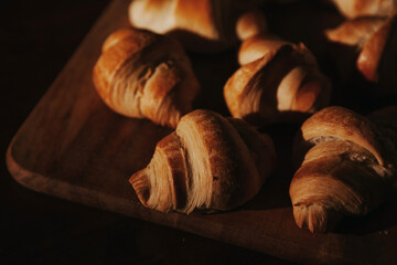 delicious homemade croissants lie on a wooden board