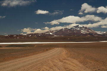 Alpine landscape. Trip into the wild. Traveling along the dirt road across the arid desert and Andes rocky mountains in Laguna Brava, La Rioja, Argentina. 