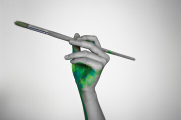 Fototapeta premium hand with a paintbrush 