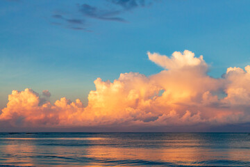 A beautiful sunrise with huge colorful clouds above the ocean in Mexico