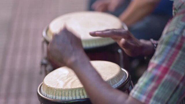 Close shot of man playing the conga in El Conde street, Santo Domingo