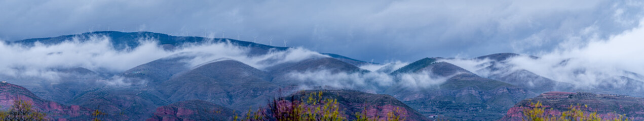 panoramic view of mountains and fogs touching the ground