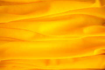 Gold yellow fabric or luxury silk satin for background. abstract gold for summer holidays.