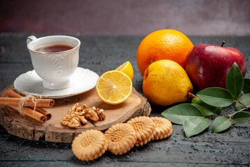 front view cup of tea with fruits and cookies on dark desk photo ceremony sweet
