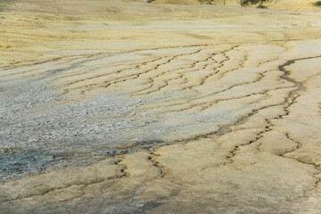 Cracked dried soil textured background from mud volcanoes park