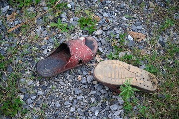 These brown rubber flip-flops are long-wearing and have a lot of abrasions placed on gravel roads,...