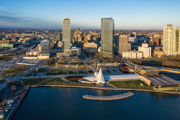 Aerial panorama view of Downtown Milwaukee at sunset. Tall downtown buildings by the lake - 399893525