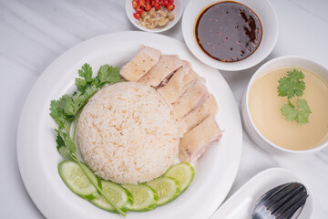 Hainanese chicken rice. Roasted Chicken Rice with soup, vegetable and Garlic, chili, ginger sauce.