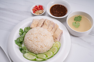 Hainanese chicken rice. Roasted Chicken Rice with soup, vegetable and Garlic, chili, ginger sauce.