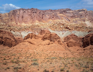 Sublime monoliths and towering sandstone cliffs on a hot partly cloudy summer day at Capitol Reef National Park in Southern Utah.