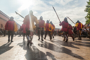 Infantry in medieval armor goes on the attack at the historical festival