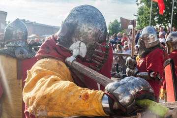 Warrior in medieval armor with an ax at the historical festival