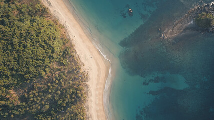 Top down of paradise resort at ocean bay aerial. Nobody tropic nature seascape at sand beach. Green tropical forest at El Nido Island, Philippines, Asia. Cinematic drone shot