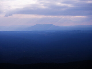 Obraz premium Cold tone sunset sky wide mountain landscape at Pha Yieb Mek in Phu Kradueng National park. Thailand.
