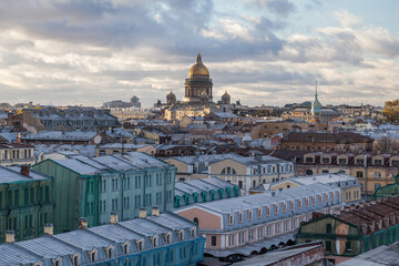 Fototapeta na wymiar The dome of St. Isaac's Cathedral rises above the rooftops of St. Petersburg